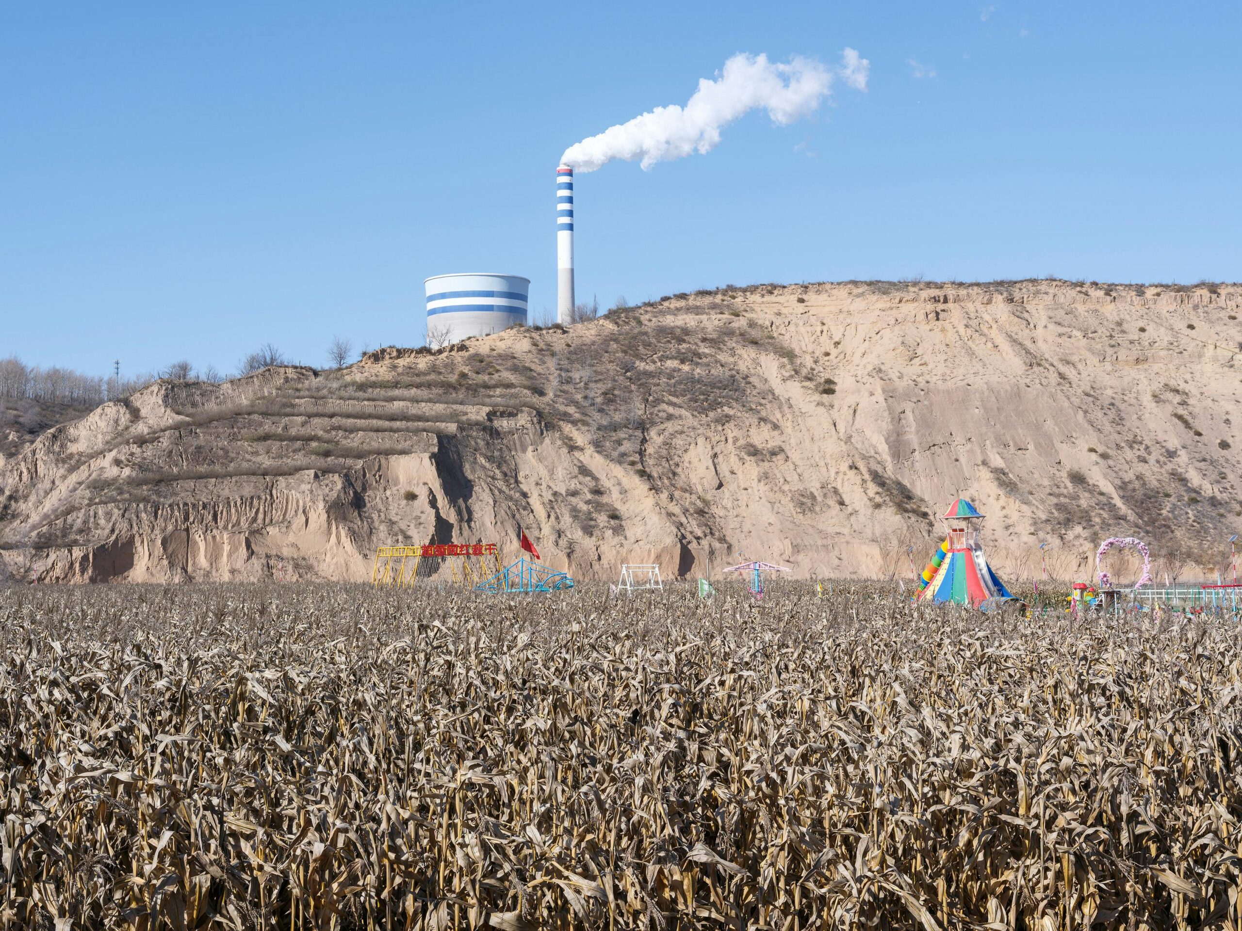 industrial landscape with cornfield and amusement park