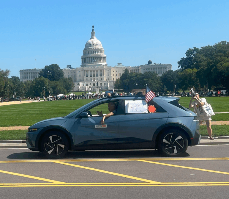 Electric car driving past U.S. Capitol part of EV Parade and Press Conference